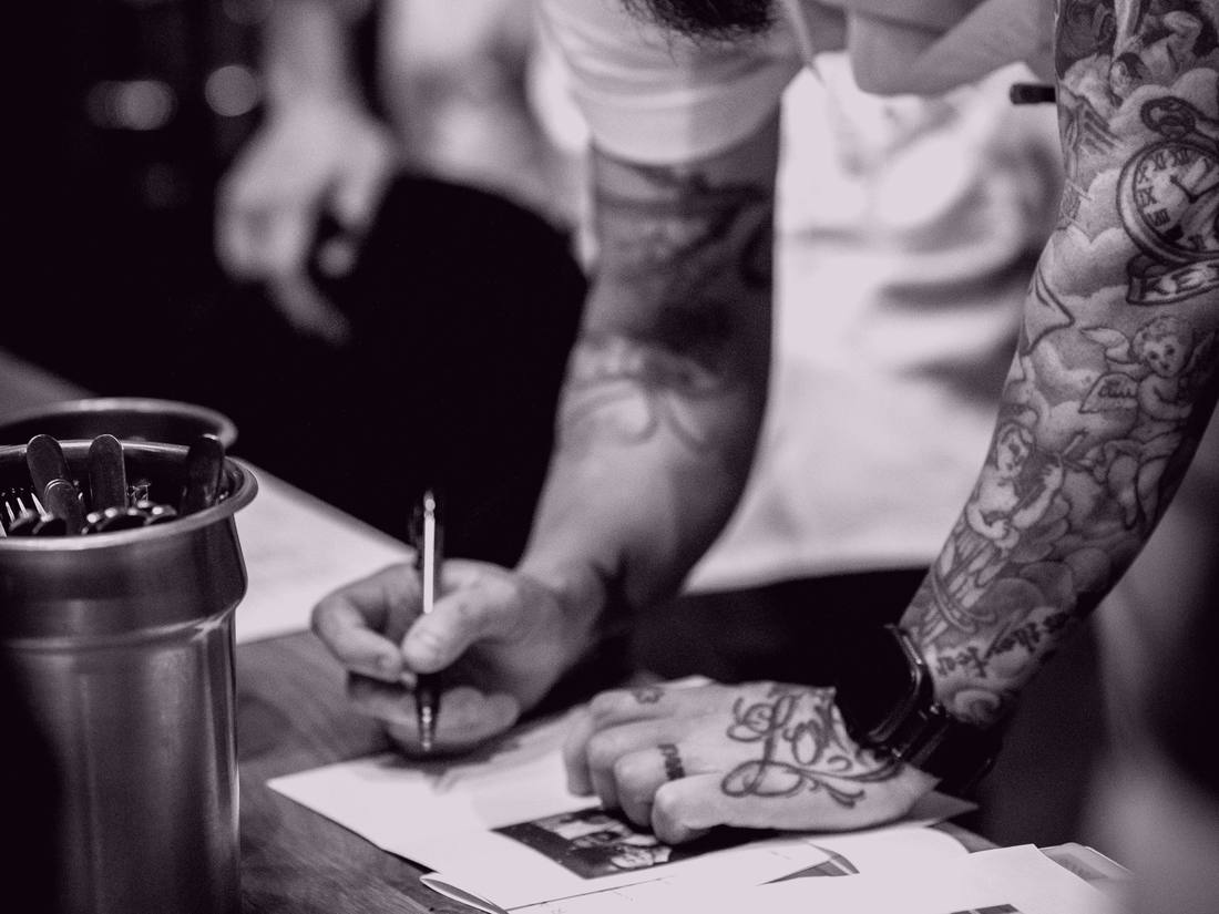 A chef writing kitchen records by hand